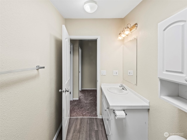 bathroom with vanity and hardwood / wood-style floors