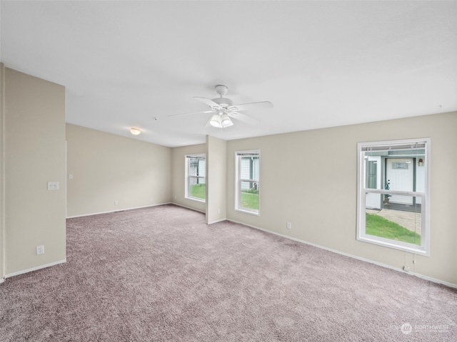 carpeted spare room with ceiling fan