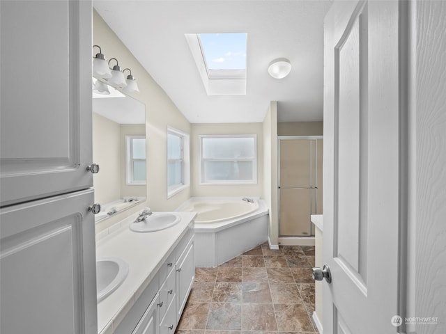 bathroom with vanity, a skylight, and shower with separate bathtub