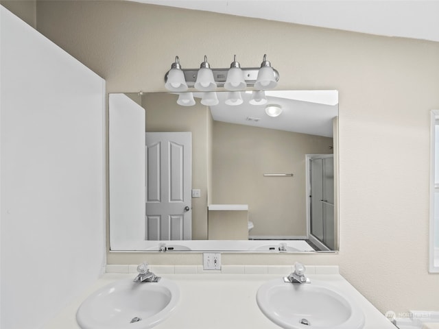 bathroom featuring vanity, lofted ceiling, a shower with shower door, and toilet