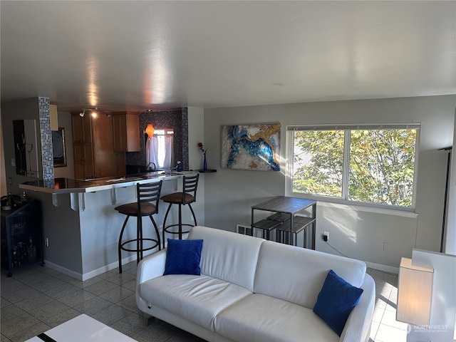 living room with sink and light tile patterned floors