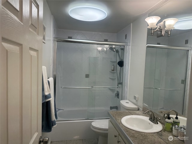 full bathroom featuring tile patterned flooring, combined bath / shower with glass door, vanity, and toilet