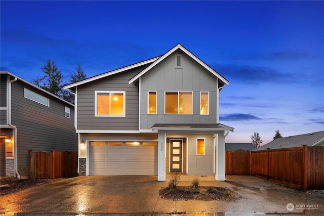 traditional-style home featuring driveway, fence, board and batten siding, and a garage