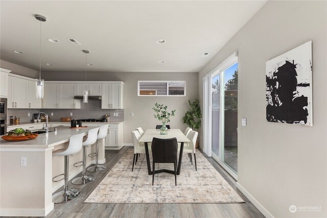 dining room featuring hardwood / wood-style floors and sink