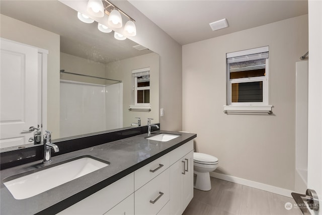 bathroom with hardwood / wood-style floors, toilet, and vanity