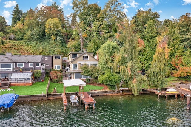 view of dock with a lawn and a deck with water view