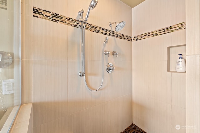 bathroom with tiled shower