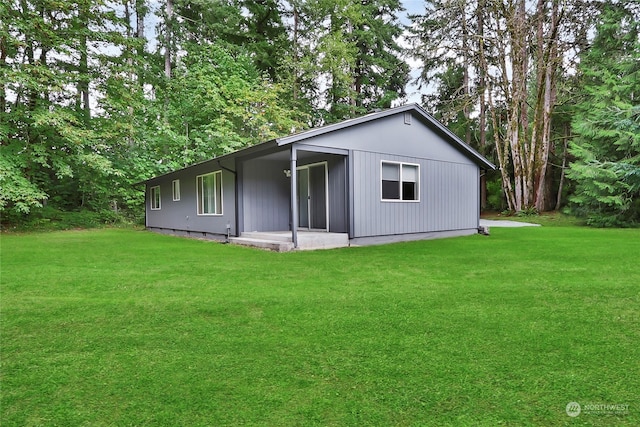 rear view of house featuring a lawn