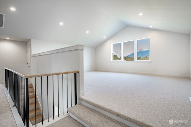 interior space with vaulted ceiling and carpet flooring