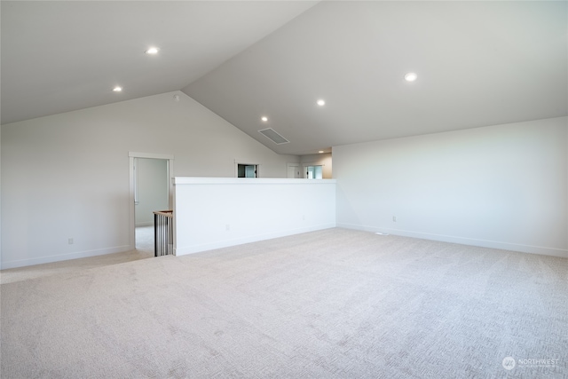 carpeted empty room featuring lofted ceiling