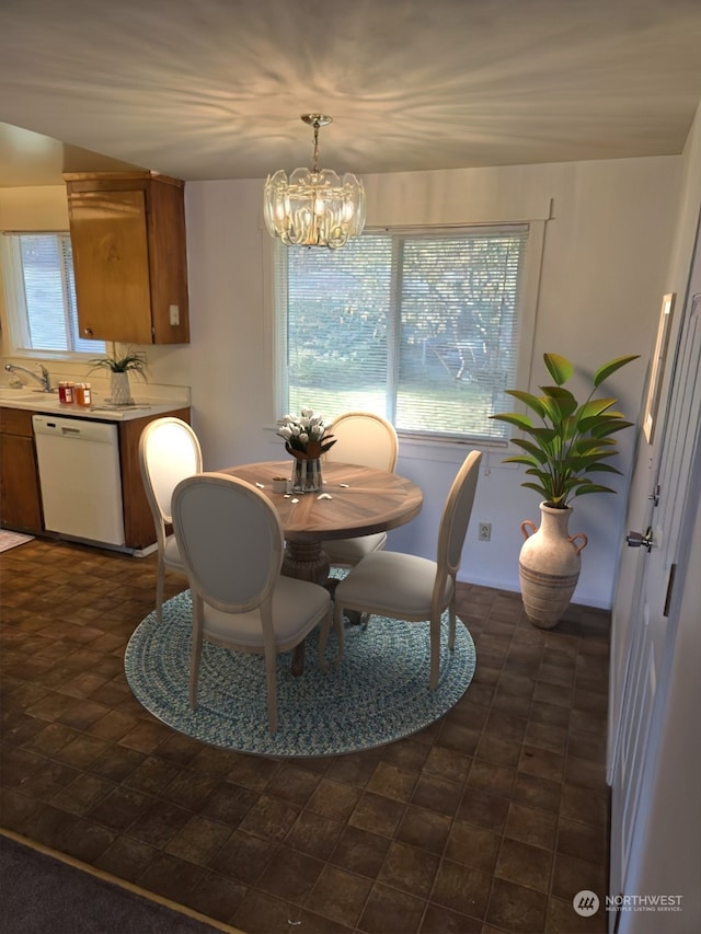 dining room with sink and an inviting chandelier