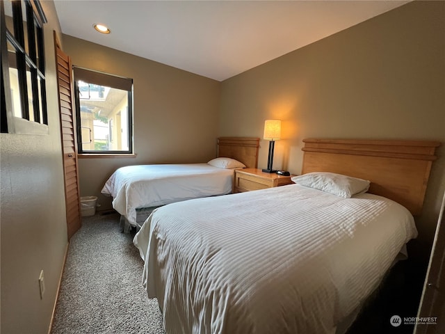 bedroom with dark colored carpet