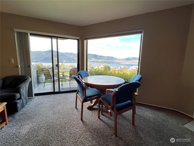 carpeted dining space with a mountain view