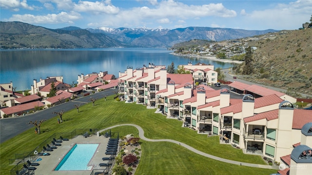 birds eye view of property with a water and mountain view