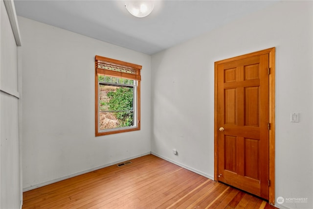 spare room with light hardwood / wood-style flooring