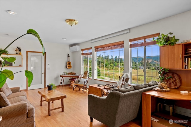 living room featuring light wood-type flooring, an AC wall unit, and a mountain view