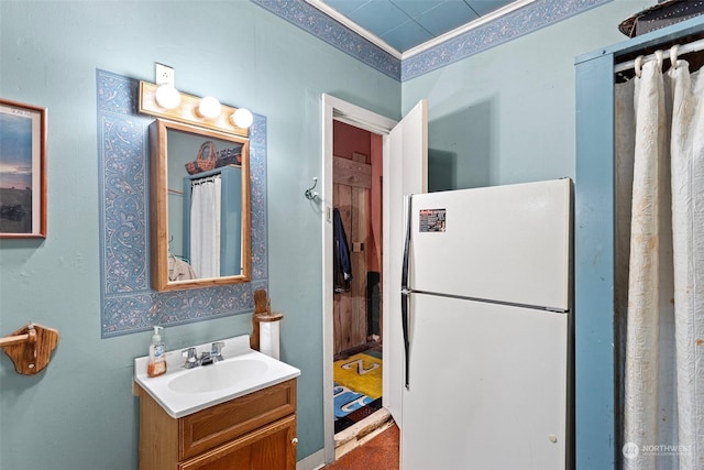 bathroom featuring crown molding and vanity