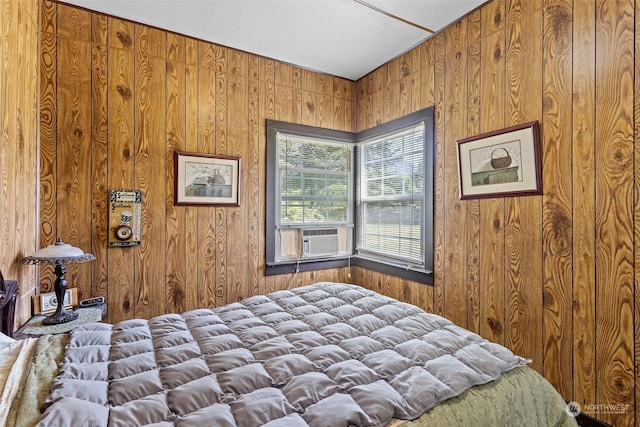 bedroom featuring wood walls and cooling unit