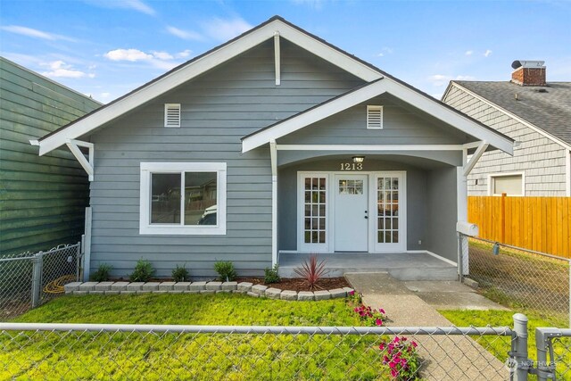 view of front of home with covered porch and fence private yard