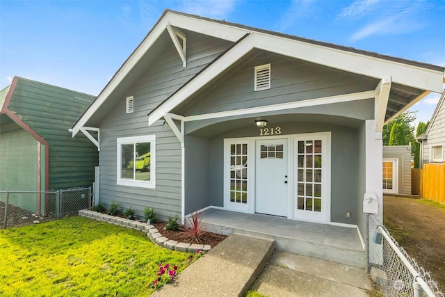 view of front facade featuring french doors and a front lawn