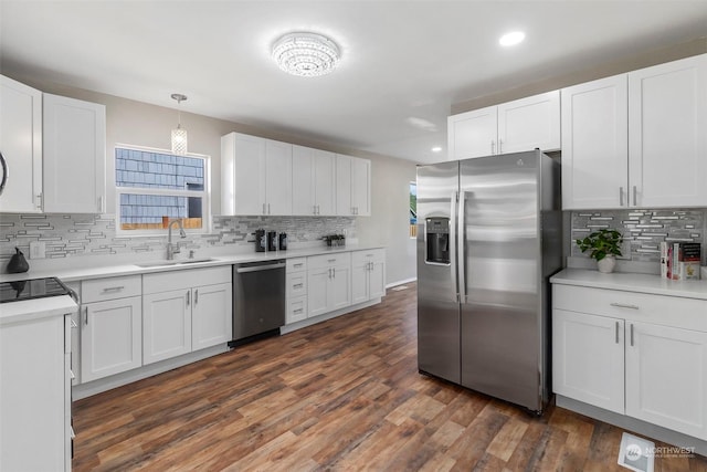 kitchen featuring a sink, appliances with stainless steel finishes, dark wood finished floors, and white cabinetry