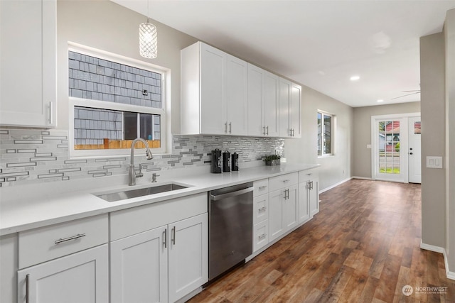 kitchen featuring backsplash, a sink, white cabinets, and stainless steel dishwasher