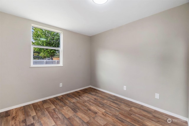 unfurnished room with wood finished floors and baseboards