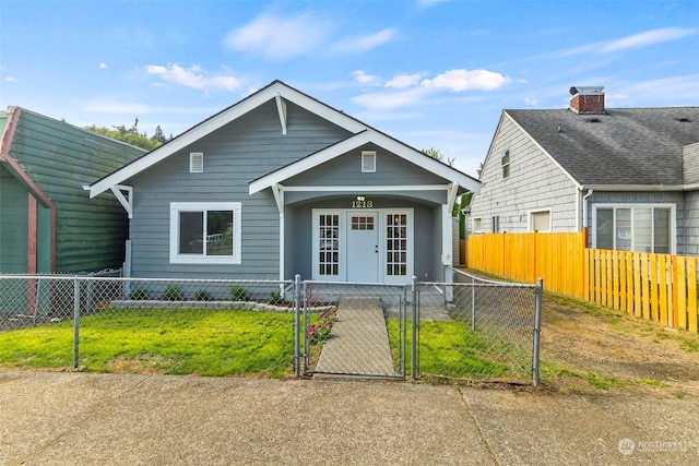 view of front of home featuring a fenced front yard and a gate