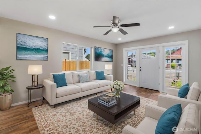 living area with a ceiling fan, recessed lighting, wood finished floors, and baseboards