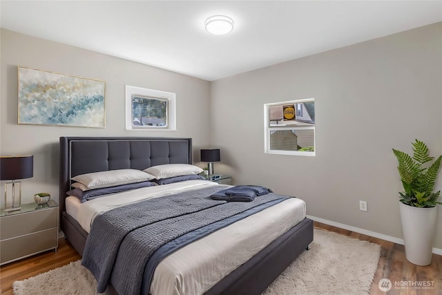 bedroom featuring baseboards and wood finished floors