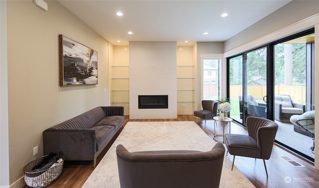 living room with hardwood / wood-style flooring and a fireplace