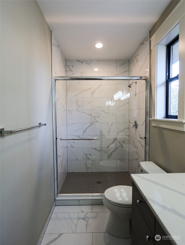 bathroom with walk in shower, toilet, and vanity