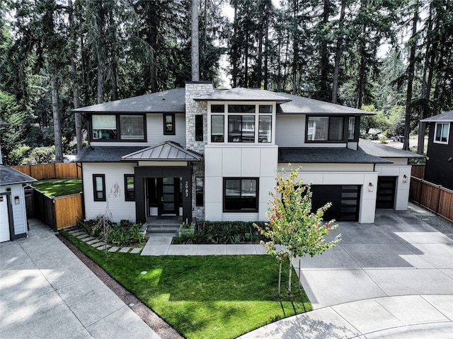 view of front of property featuring a front yard and a garage