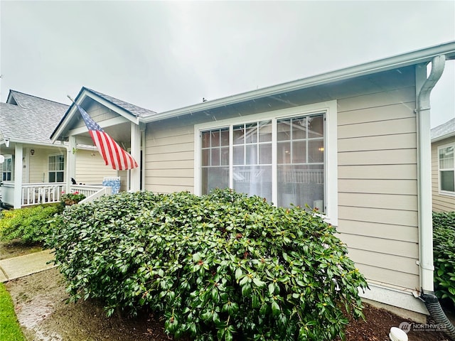 view of side of property featuring a porch