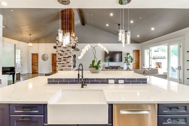 kitchen featuring hanging light fixtures, sink, dark wood-type flooring, light stone countertops, and lofted ceiling with beams