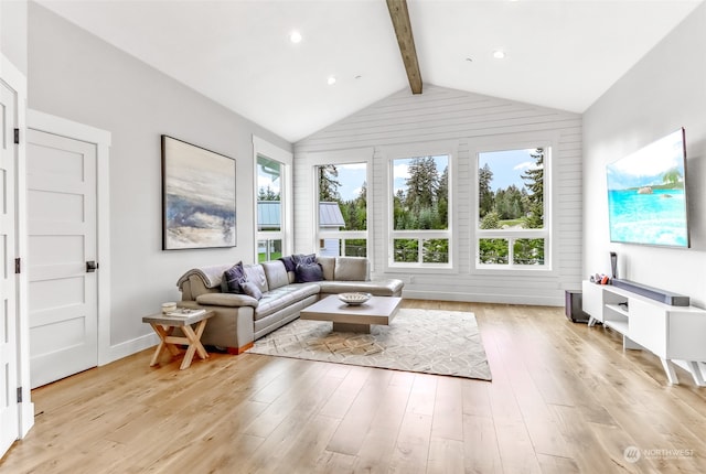 living room with vaulted ceiling with beams and light hardwood / wood-style floors