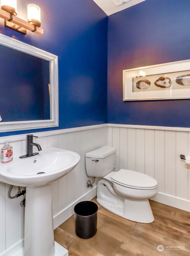 bathroom with toilet and wood-type flooring