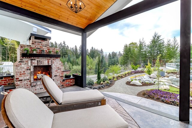 view of patio with an outdoor brick fireplace