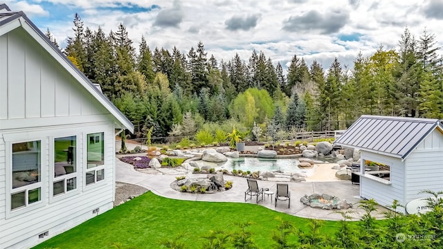 view of yard with an outdoor fire pit, a patio, and a shed