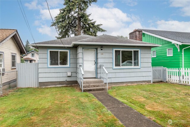 bungalow-style home featuring a front yard