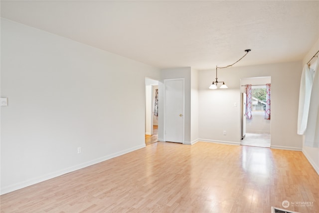 spare room featuring light wood-type flooring