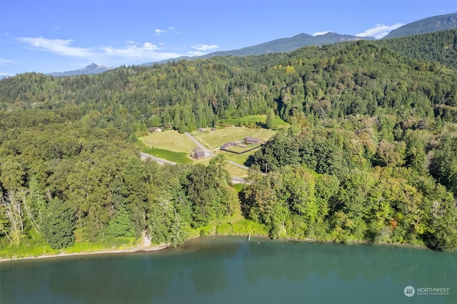 drone / aerial view featuring a water and mountain view