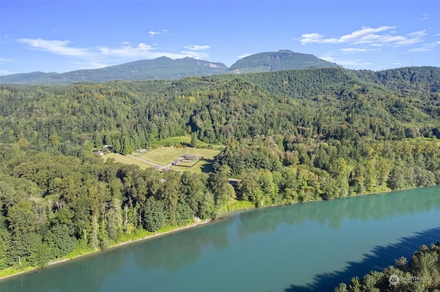 drone / aerial view featuring a water and mountain view