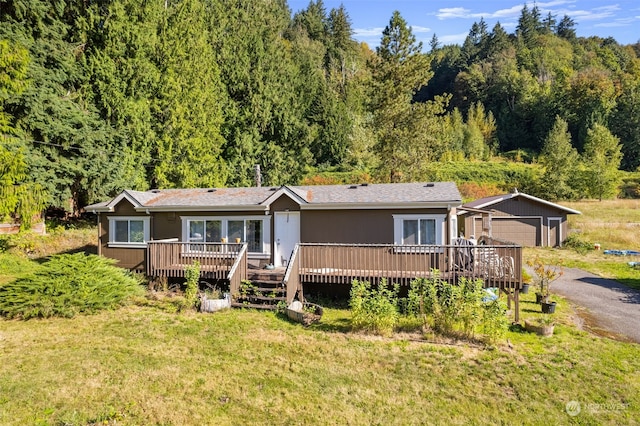 view of front of home featuring a front yard and a wooden deck