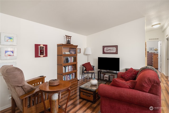 living room with dark hardwood / wood-style floors and vaulted ceiling