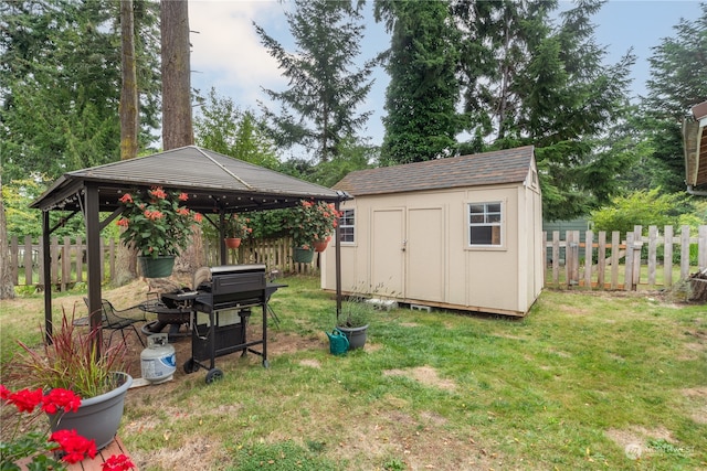 view of yard featuring a shed, an outdoor fire pit, and a gazebo