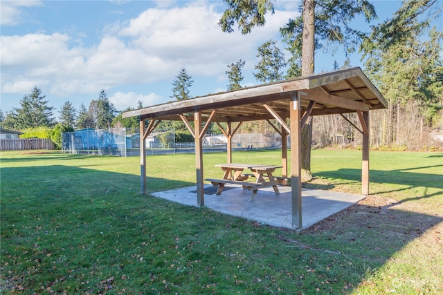 surrounding community with a yard and a patio