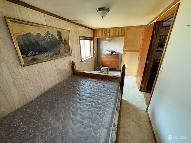 hall with crown molding, wooden walls, and carpet floors