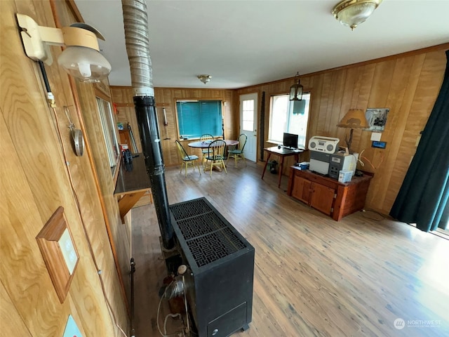 living room with light wood-type flooring and wood walls