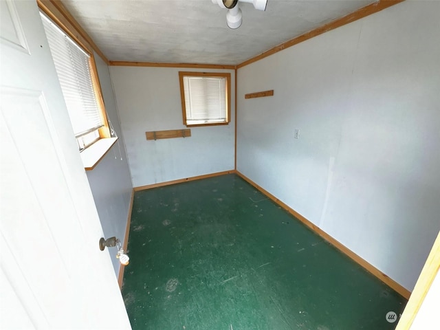 unfurnished room with baseboards and carpet flooring